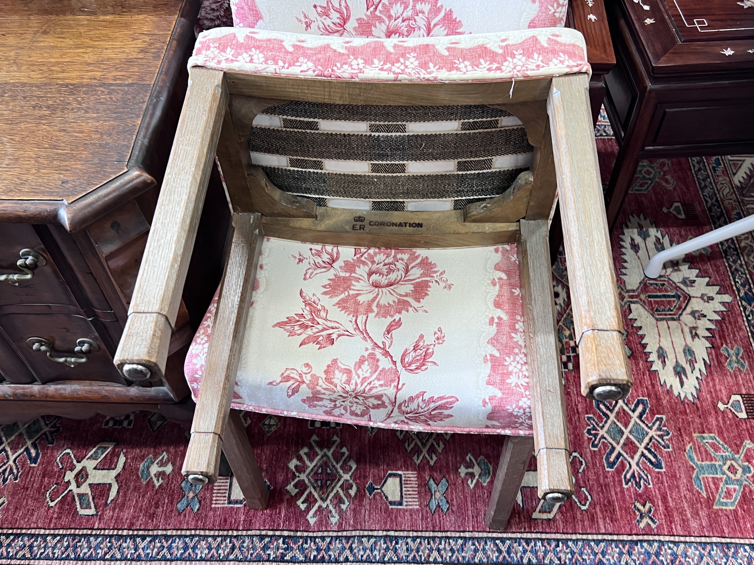 A reupholstered Coronation chair , the back applied with a George VI fabric remnant and an Elizabeth II Coronation stool